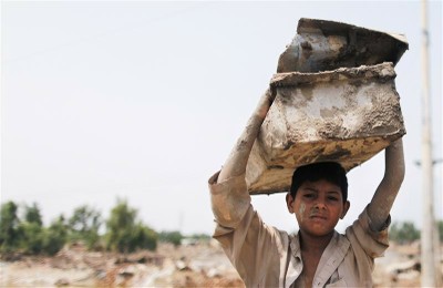 Pakistan flood boy carrying load