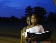 A child and mother enjoying a book